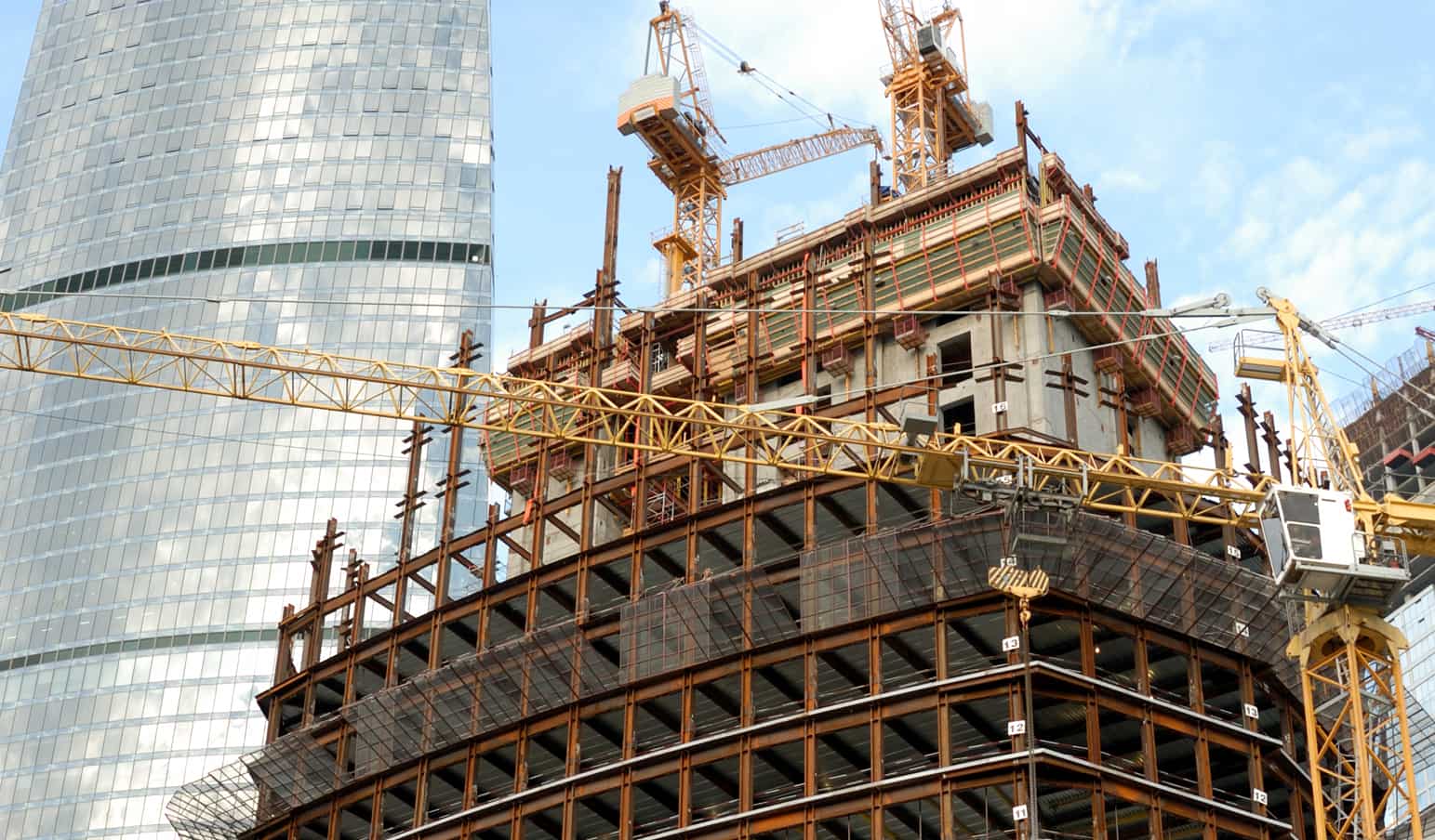 Example of large building. Building. Cranes. Steel beams.